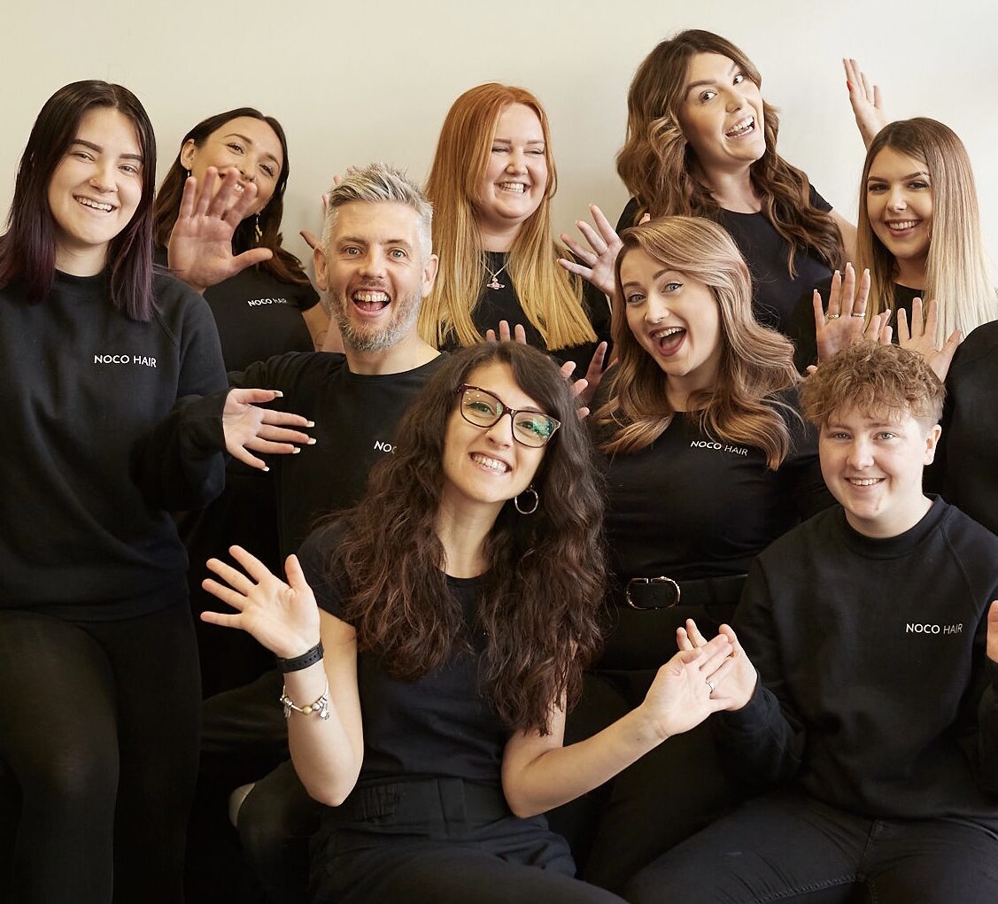 Team members doing excited pose for team photo