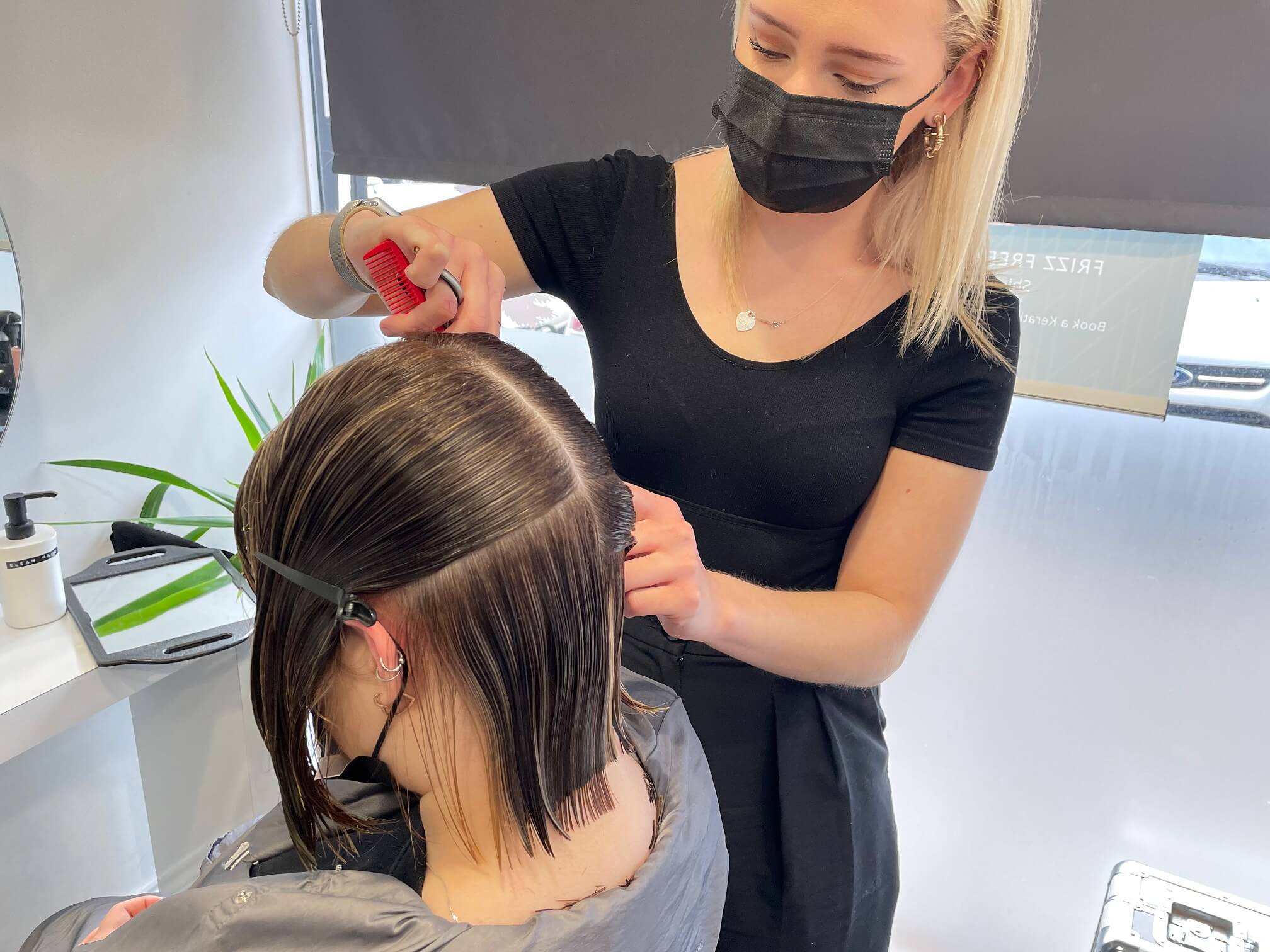 Short brown hair being sectioned and trimmed