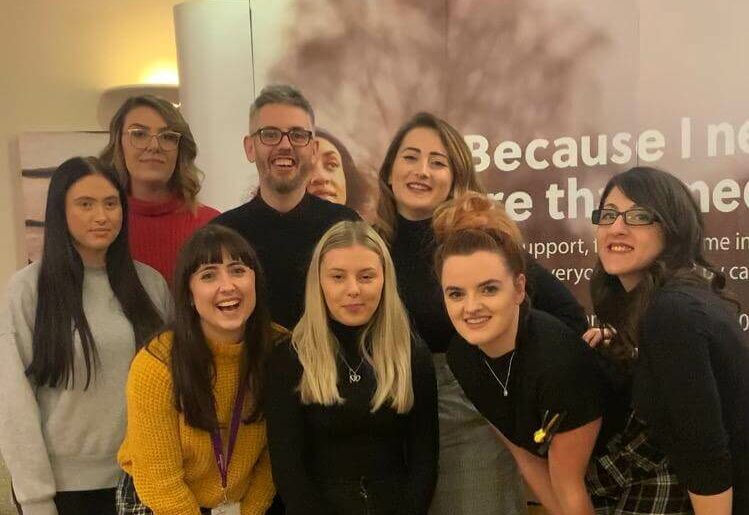 Group of hairdressers posing for team photo