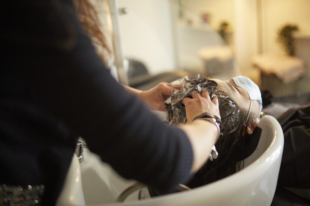 hairdresser giving a head massage