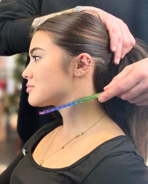 Hair consultation at NOCO Hair Bristol with stylist assessing hair length and condition before cut or colour service.